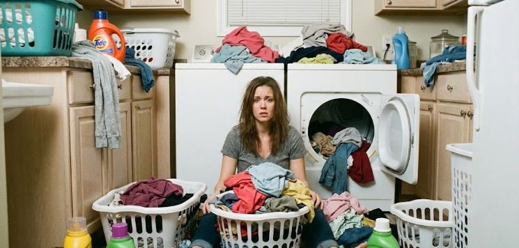 ADHD mom burned out in laundry room.